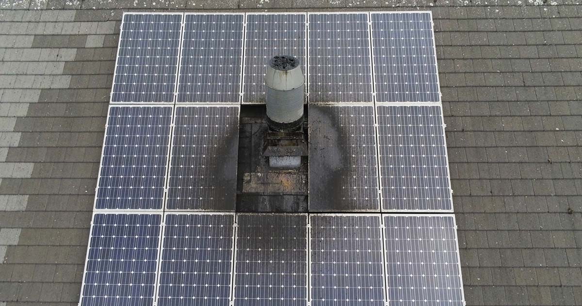 A solar panel installed on the roof of a residential house, harnessing solar energy for sustainable power.